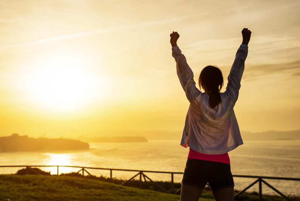 Successful Sporty Woman With Arms Up